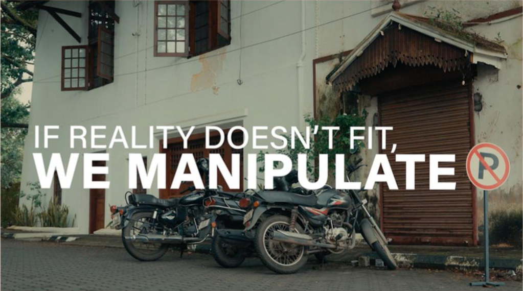 Motorcycles parked by a shuttered shopfront with the line: if reality doesn't fit, we manipulate